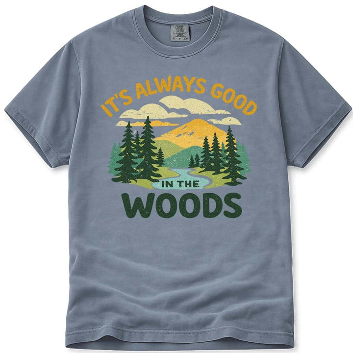 Blue t-shirt with nature graphic and 'It's Always Good in the Woods' text on a white background